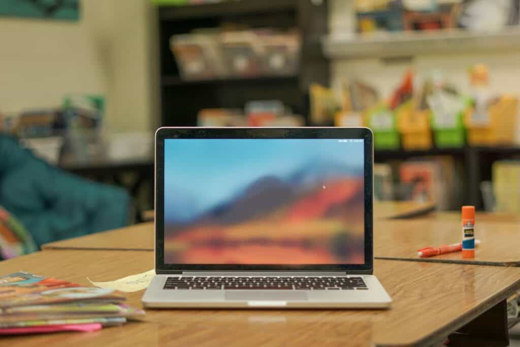 Laptop on a desk in a school classroom, relevant to making a school website stand out