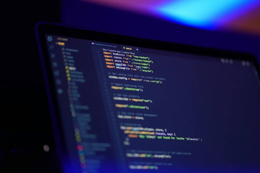 Laptop screen displaying colourful code, relevant to building an HTML banner