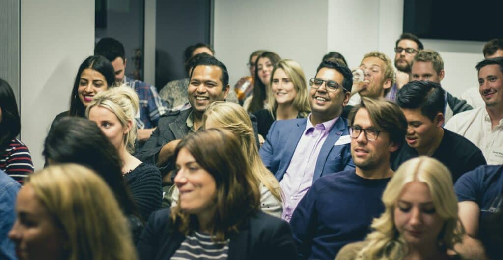 Diverse group of adults listening attentively during a seminar, like attendees at a first academic conference