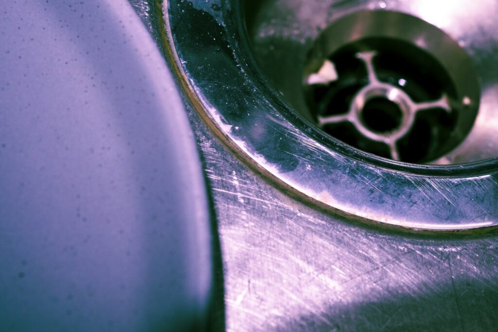 Close-up of a stainless steel sink drain, relevant to DIY plumbing repairs going wrong